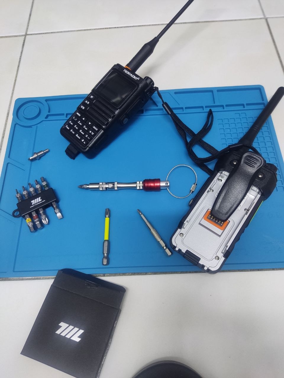 711L Pen Driver TS on radio electronics bench with handheld transceivers and bit holder