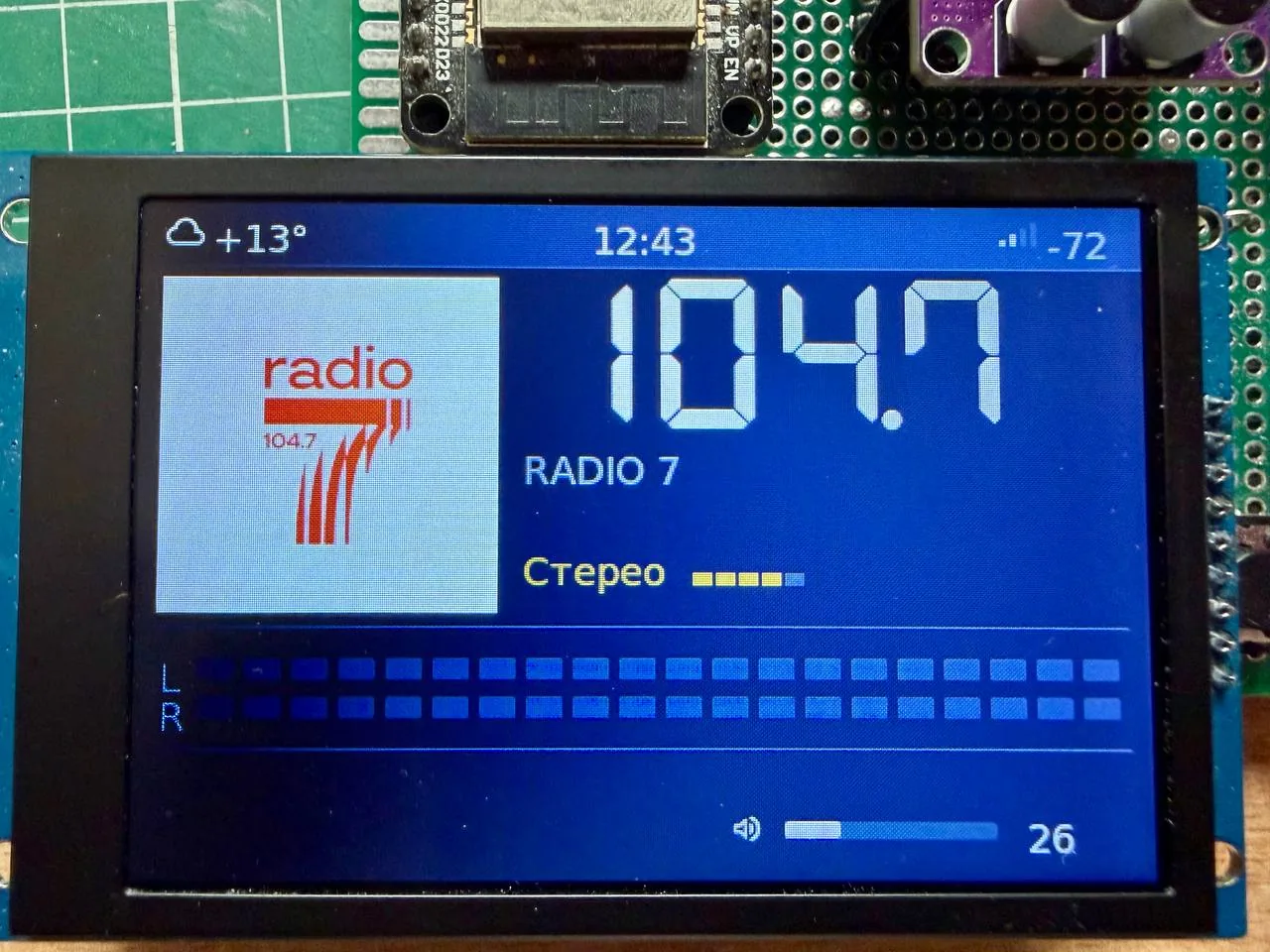 JRadio FM radio screen with large frequency, RDS station name, preset picture, stereo flag and signal level