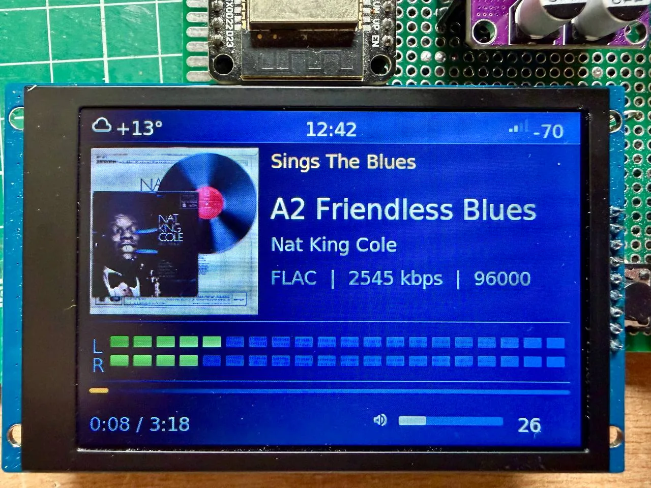 JRadio file player showing FLAC track with album cover, format, bitrate, VU meter and track position