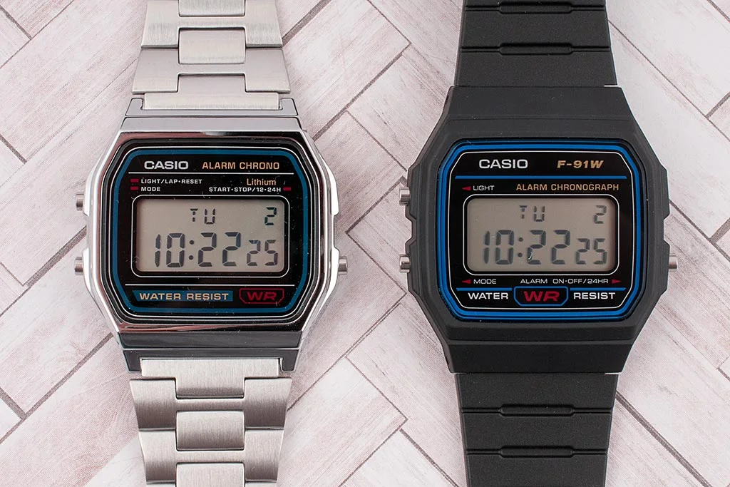Silver Casio A158 and black Casio F-91W side by side, both compatible with the Ollee Watch drop-in module