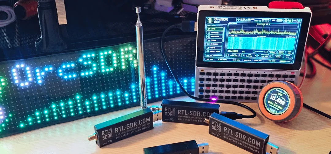 OrcSDR workbench with LED sign, telescopic antenna, Tab5 cyberdeck, M5Dial remote and RTL-SDR Blog V4 dongles