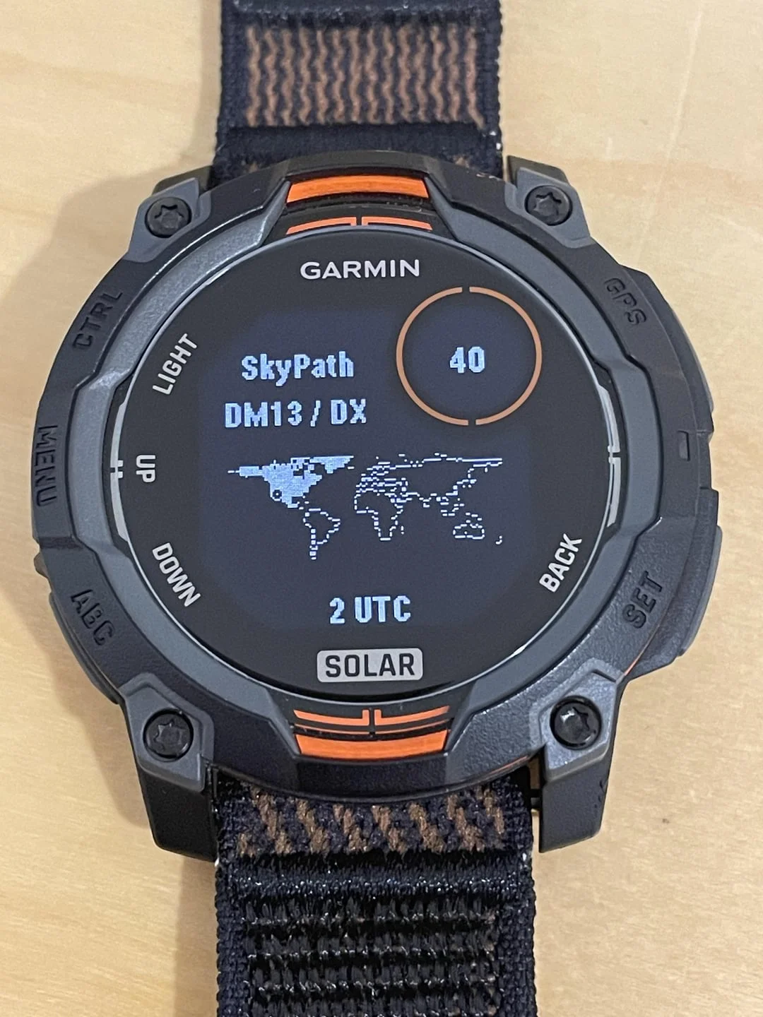 Garmin Instinct 3 Solar showing SkyPath HF propagation glance with DM13 DX grid, pixel world map, 40m band and 2 UTC