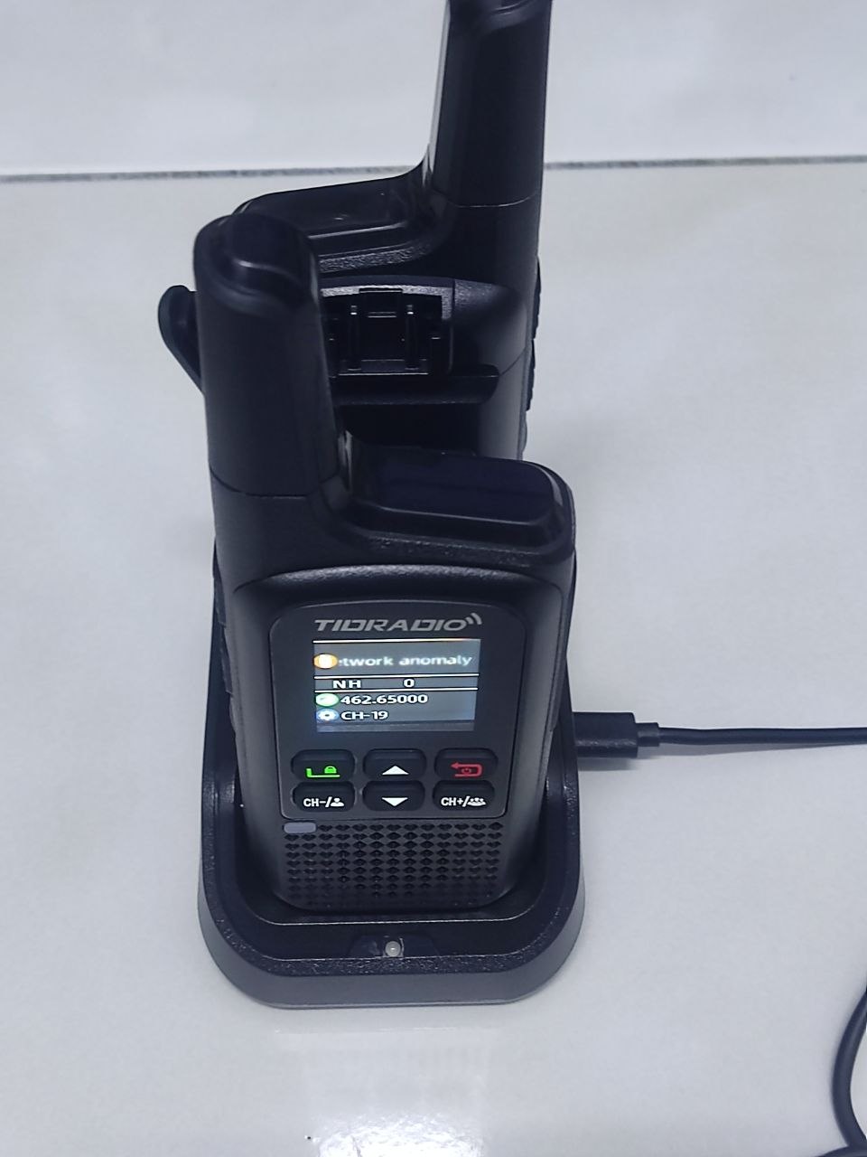 TIDRADIO TD-M2 Pro sitting in dual-slot desktop charging cradle